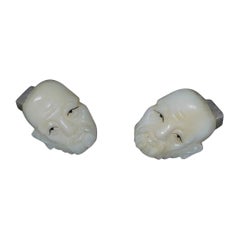 Japanese a pair of finely carved cuff links with opposing faces