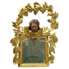 Miroir italien en bois sculpté et doré avec guirlande de laurier et putto 1800