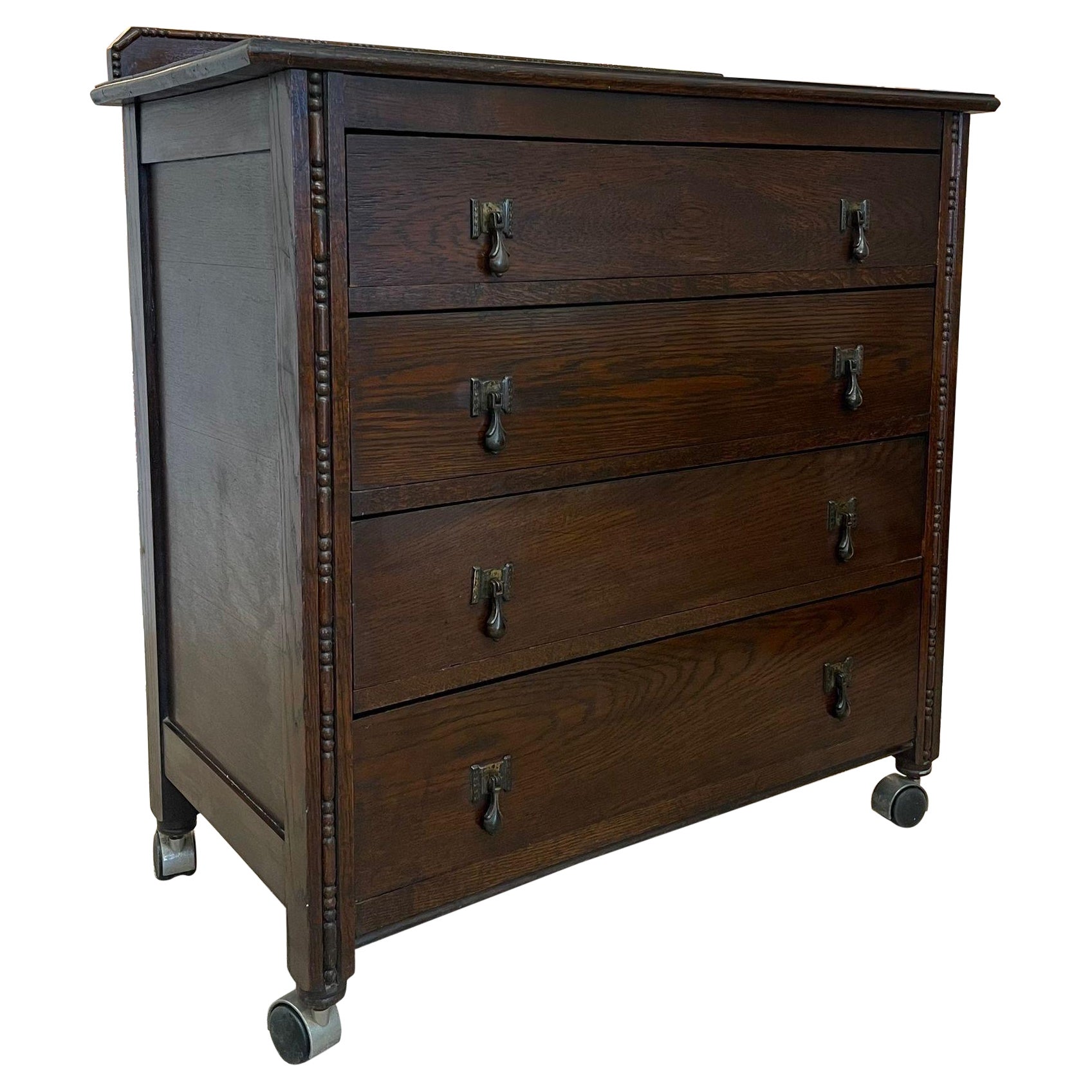 Vintage Four Drawer Dresser on Casters With Carved Wood Detailing. For Sale