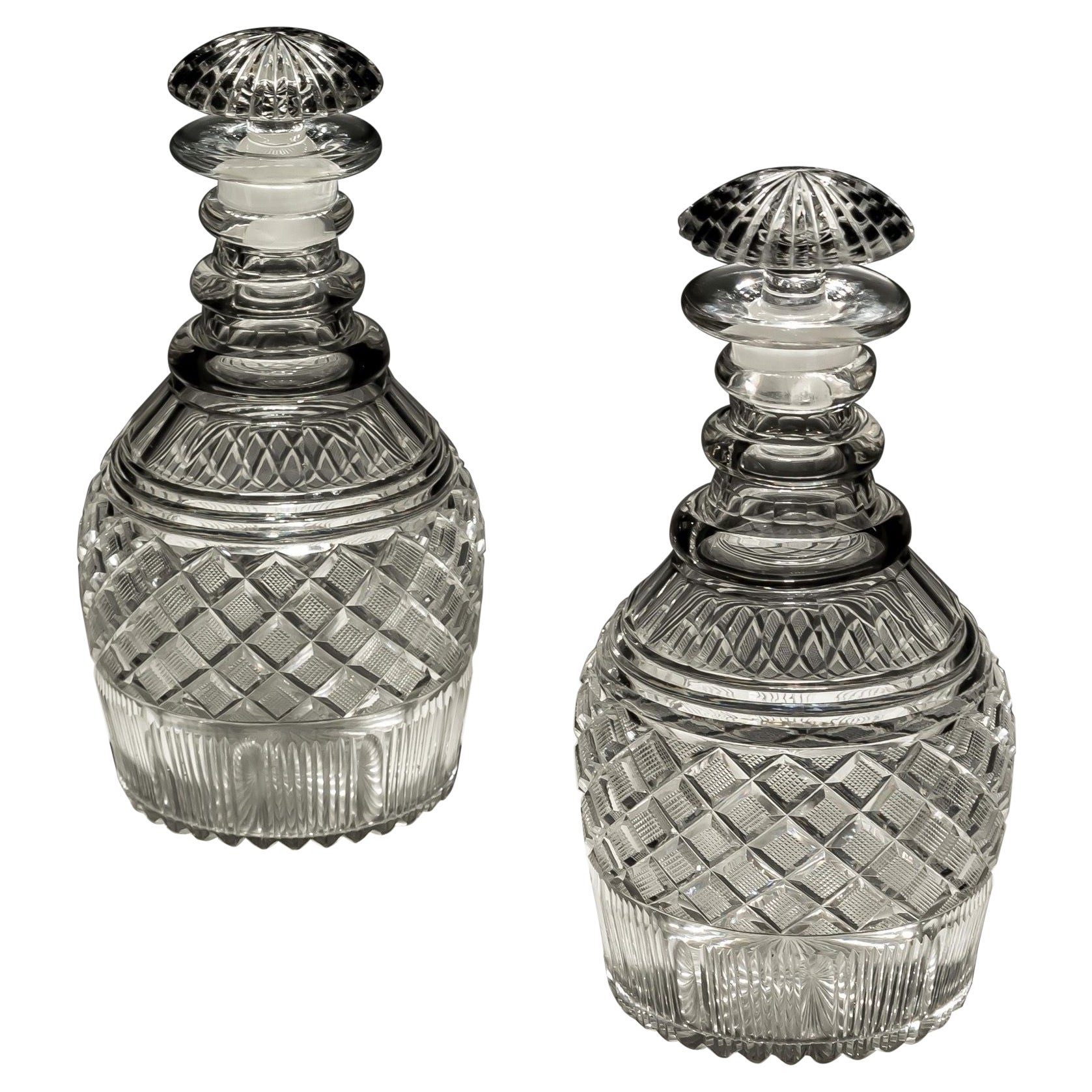 A pair of strawberry diamond cut Georgian decanters