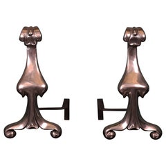 A Pair of Art Nouveau Polished Steel Fire Dogs