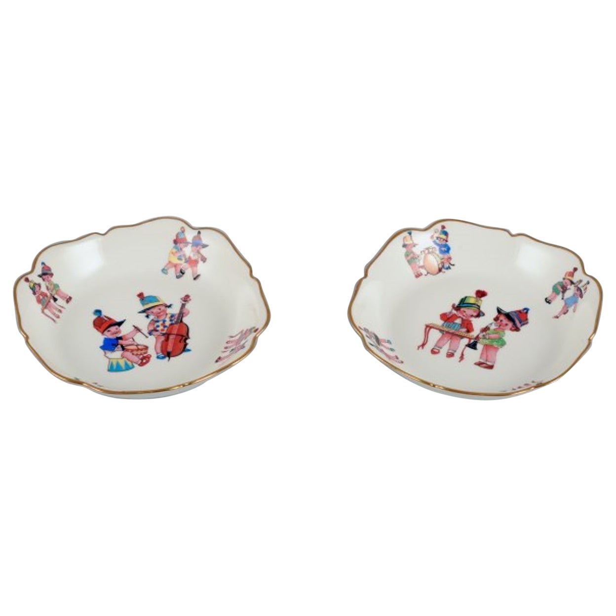 Limoges, France. Two deep children's plates in porcelain with gold rim.  For Sale