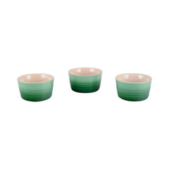 Le Creuset, France. Three green stoneware pie dishes with hand-glazed finish. 