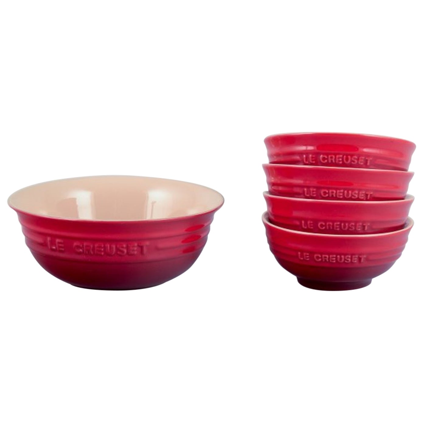 Le Creuset, France. Set of five red stoneware bowls. 21st c.
