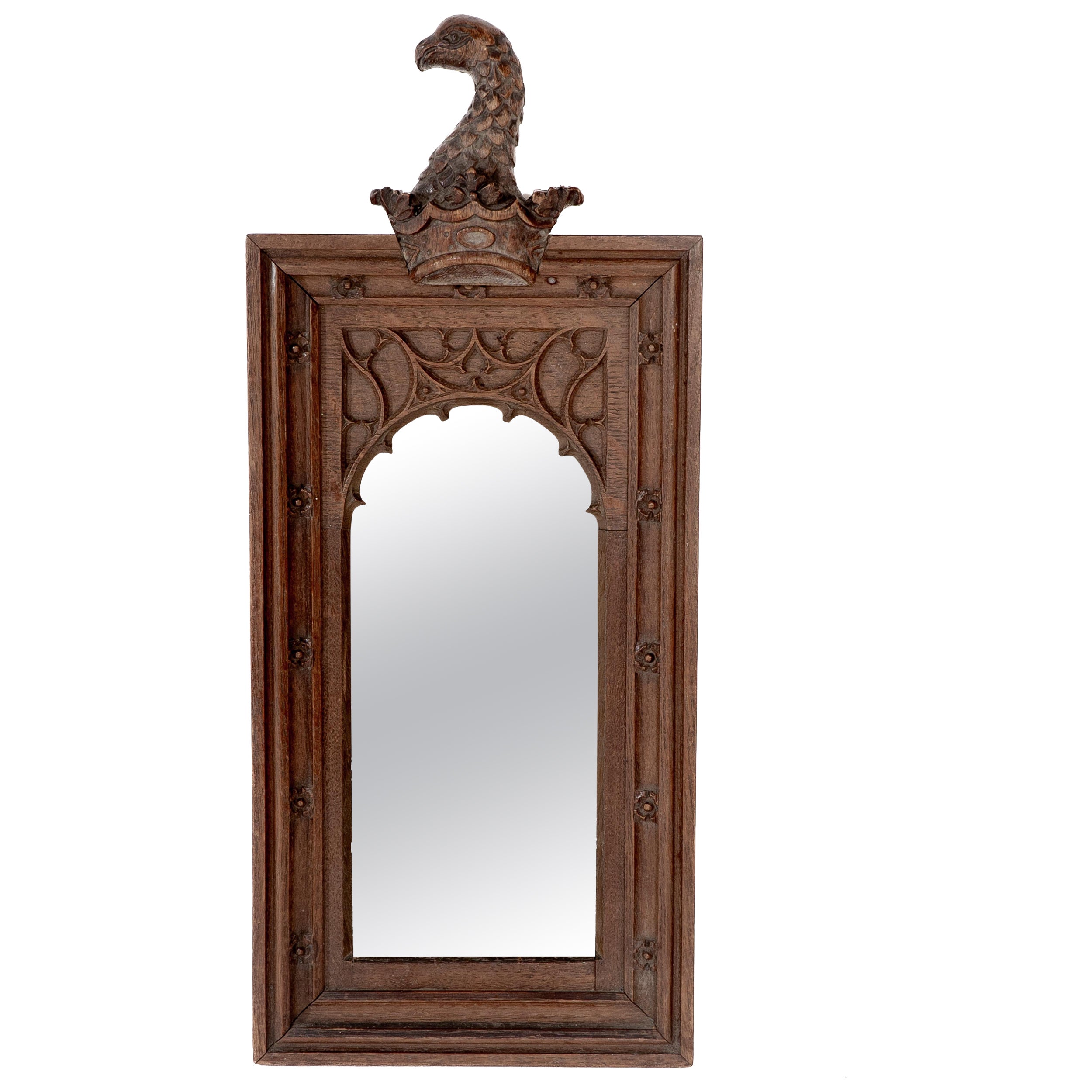 A Gothic Revival oak mirror surmounted with a carved eagle to the top For Sale