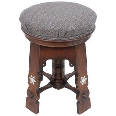 Liberty and Co attri. A rare Moorish walnut revolving stool with Moorish arches