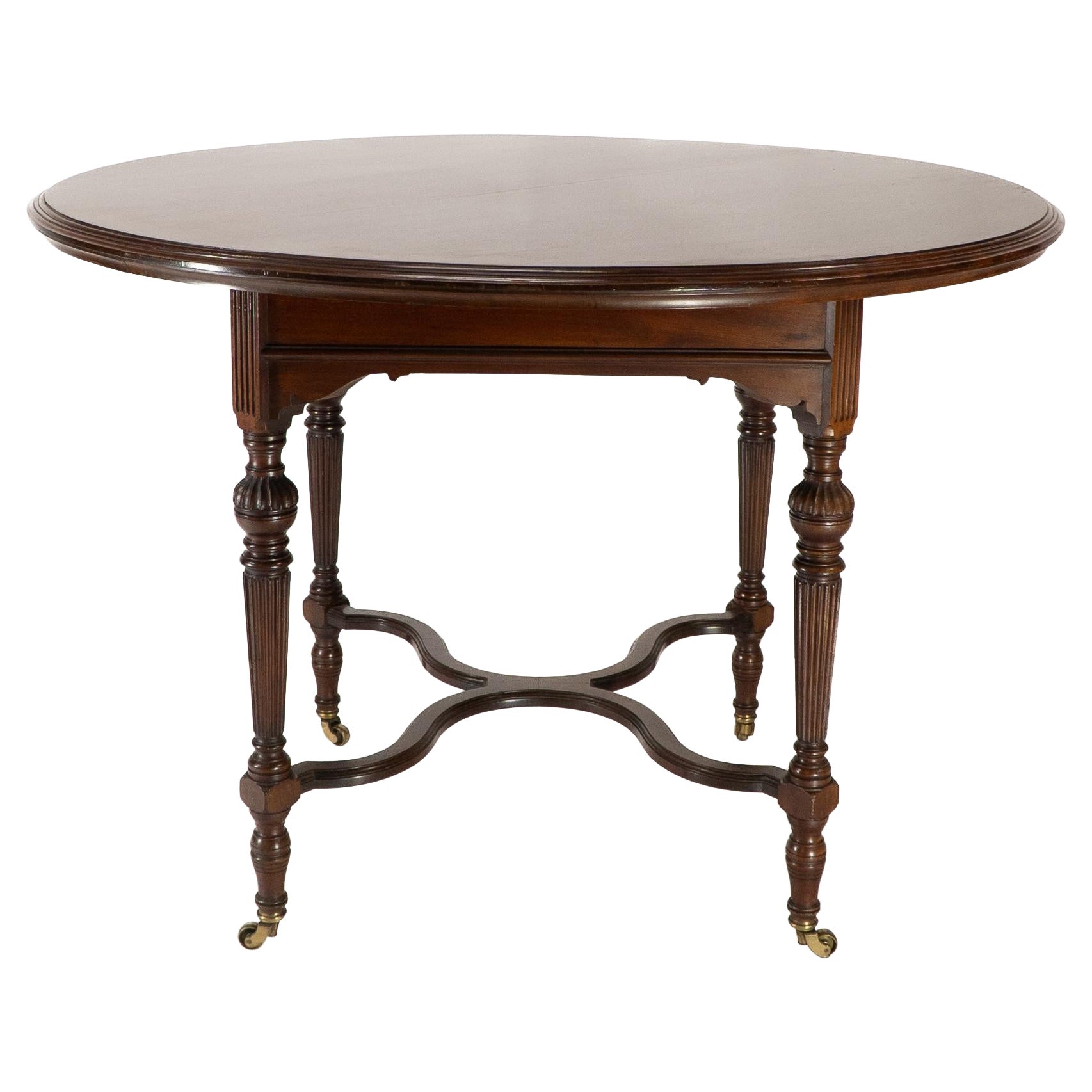 Collinson & Lock attributed. An Aesthetic Movement walnut circular center table For Sale