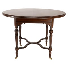 Antique Collinson & Lock attributed. An Aesthetic Movement walnut circular center table