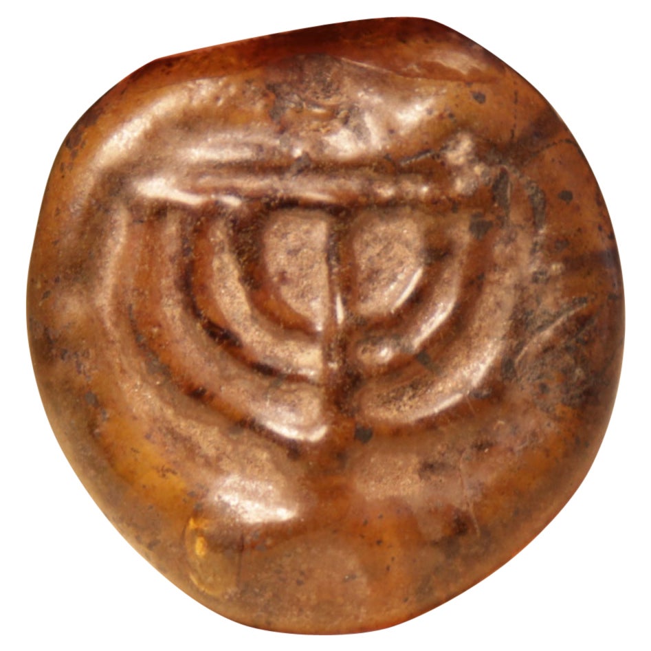 Late Roman/Byzantine Jewish Amber Color Glass Amulet with Menorah For Sale