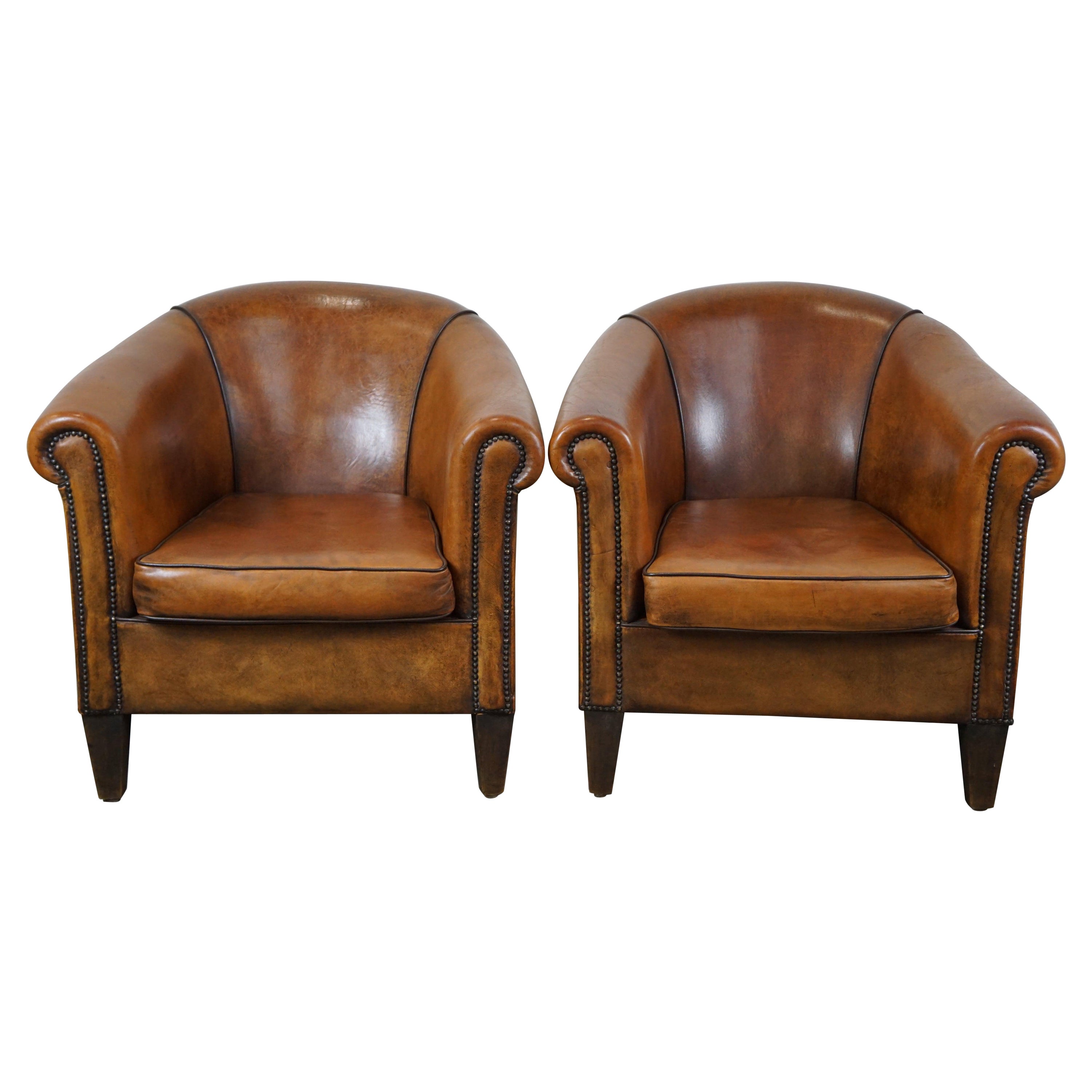 Set of 2 amazing and characterful sheep leather club armchairs with warm color For Sale