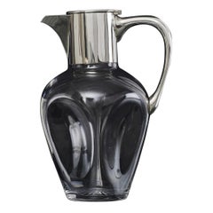 Pinched glass wine jug with silver mounts