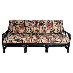 Boho Chic Black Wicker Rattan Sofa With Tan Red and Black Cushions