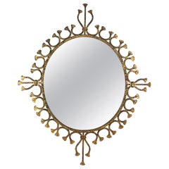 Miroir / Miroir mural Hollywood Regency en fer forgé doré, ovale et ensoleillé