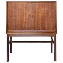 A rare mid century modern tall bar cabinet with a pull out surface