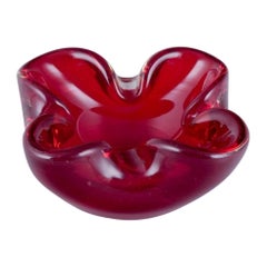 Murano, Italy. Art glass bowl in deep red glass with air bubbles inside. 