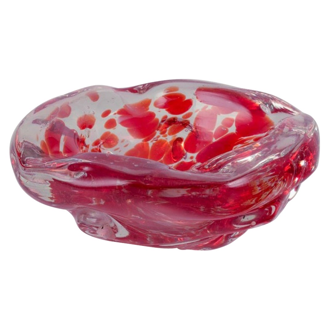 Murano, Italy. Art glass bowl. Clear and red glass with air bubbles inside.