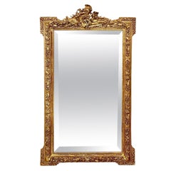 Miroir en bois doré orné Louis XVI du 19ème siècle