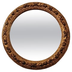 SECOND HALF OF THE 19th CENTURY ROUND MIRROR IN GOLDEN WOOD