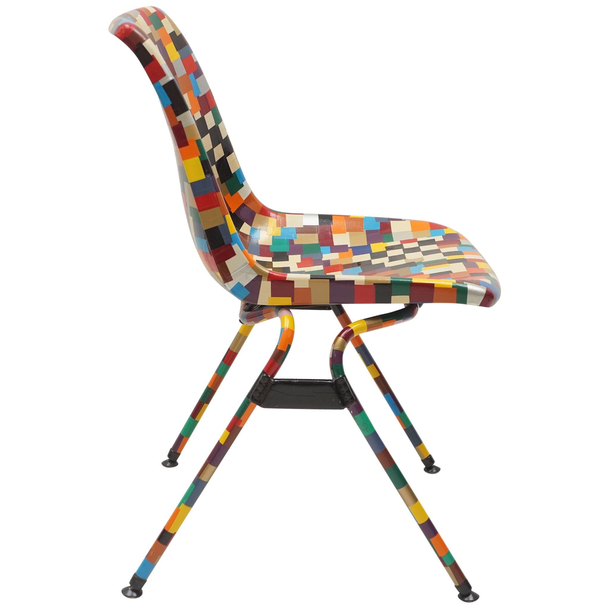Multi-color decoupage chair in mosaic pattern with metal tubular legs.