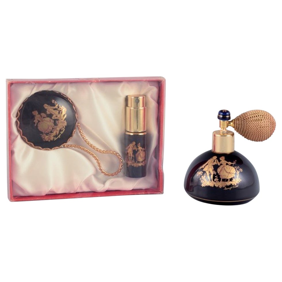 Limoges, France. Two porcelain perfume atomizers and a makeup mirror