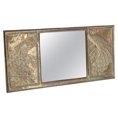 Antique An Aesthetic Movement brass mirror with stylized peacocks perched on a branch