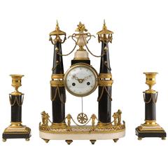 Gilt Bronze Marble Clock and Candlesticks. Louis XVI Period