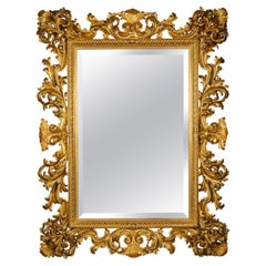 A Large and Impressive Baroque Style Carved Giltwood Mirror