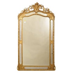 Antique Mirror, With Face And Volutes, Gilded In Leaf Of Pure Gold, 19th.