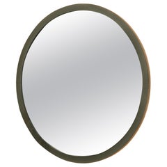 Globe circular mirror with leather-covered edge and exposed stitching