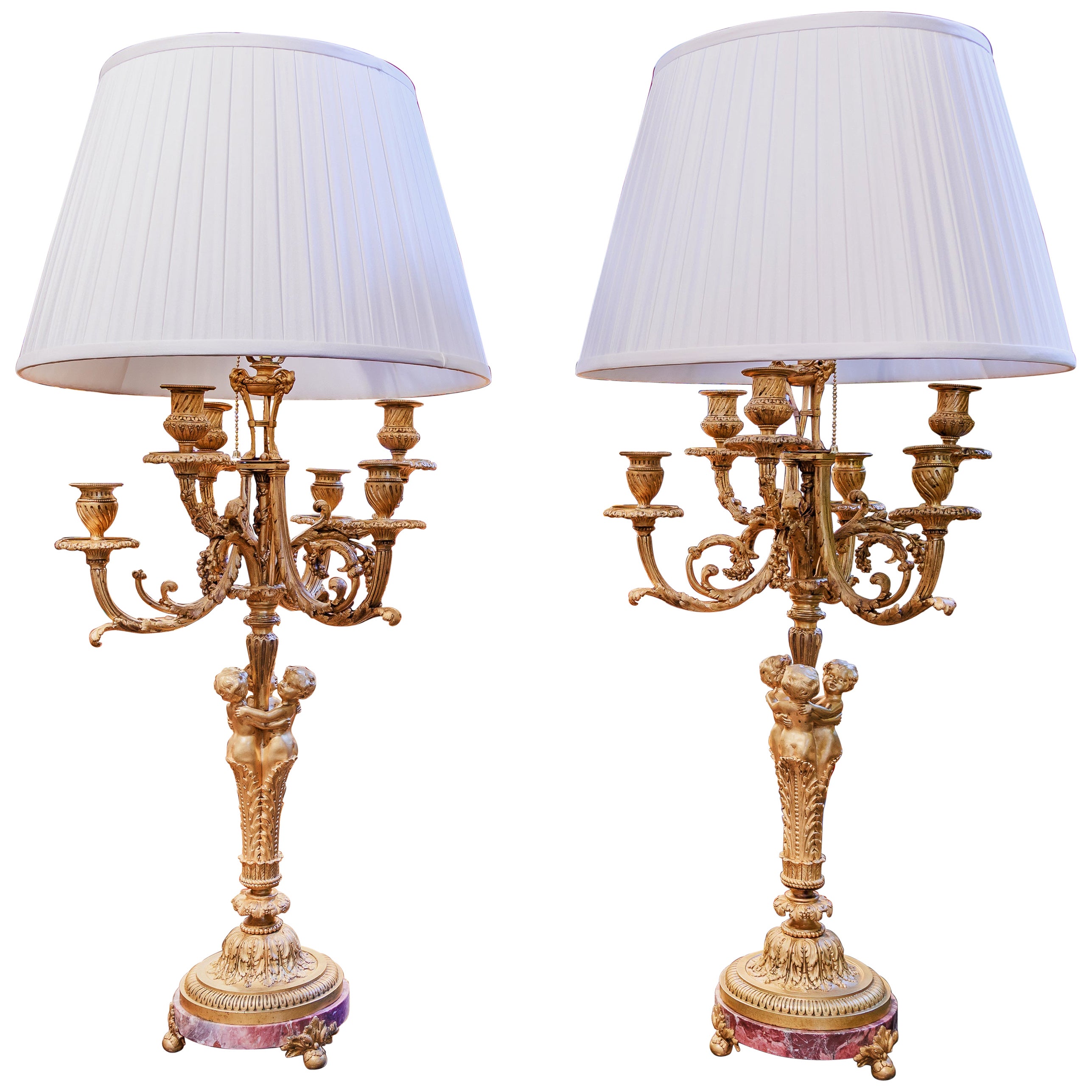 A fine pair of French Louis Philippe gilt bronze cherub candlabrum lamps