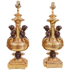 Antique A fine pair of 19th century French large gilt bronze cherub lamps. 