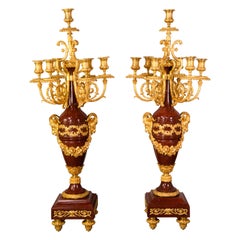 Pair of candelabras. Rouge Griotte marble, gilt bronze. France, 19th century