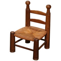 Early 20th Century French Carved Walnut Child Chair with Rush Seat