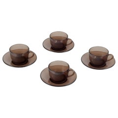 Vereco, France. Set of four coffee cups and saucers in smoked art glass. 1970s