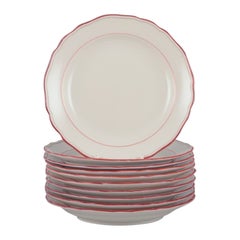 Vintage Meissen, Germany. Set of ten porcelain plates with coral red trim.