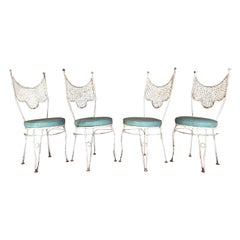 Set of four wrought iron mid century modern vintage patio chairs