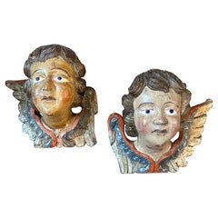A Pair of 1750s Baroque Lacquered Wood Sculptures of Angel Heads with Wings