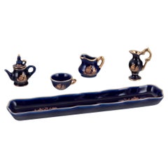 Limoges, France. Miniature porcelain set: cup, teapot, two pitchers and tray