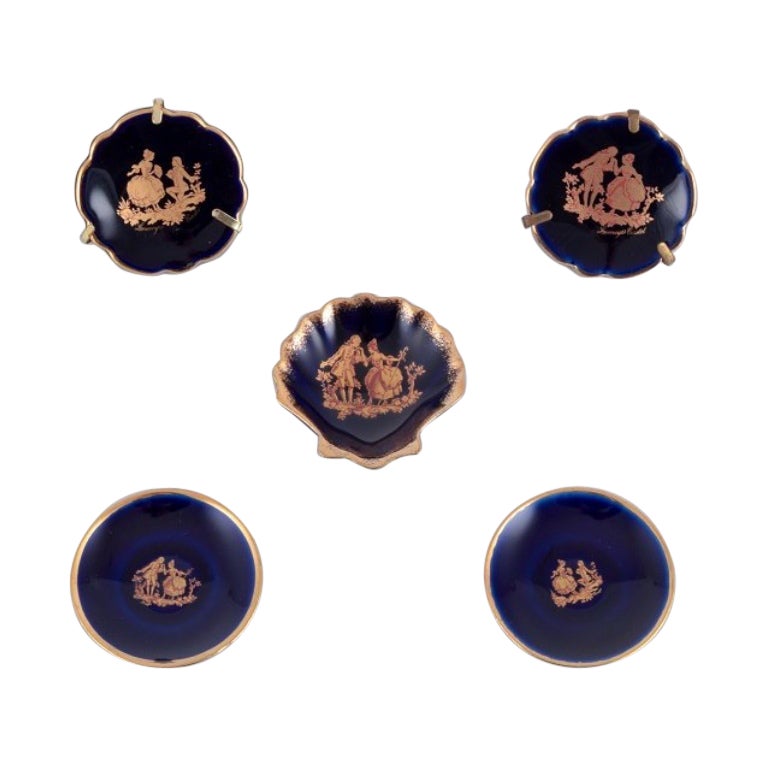 Limoges, France. Five small pieces of porcelain decorated with gold leaf.