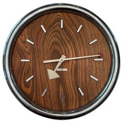 Vintage 1970s Howard Miller zebrawood and chrome wall clock designed by Arthur Umanoff