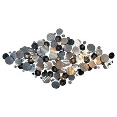 C. Jeré Artisan House metal wall sculpture of circles or raindrops