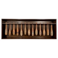 Collection of 13 Early 20th C. Juggling Pins in Wall-Mounted Display Box