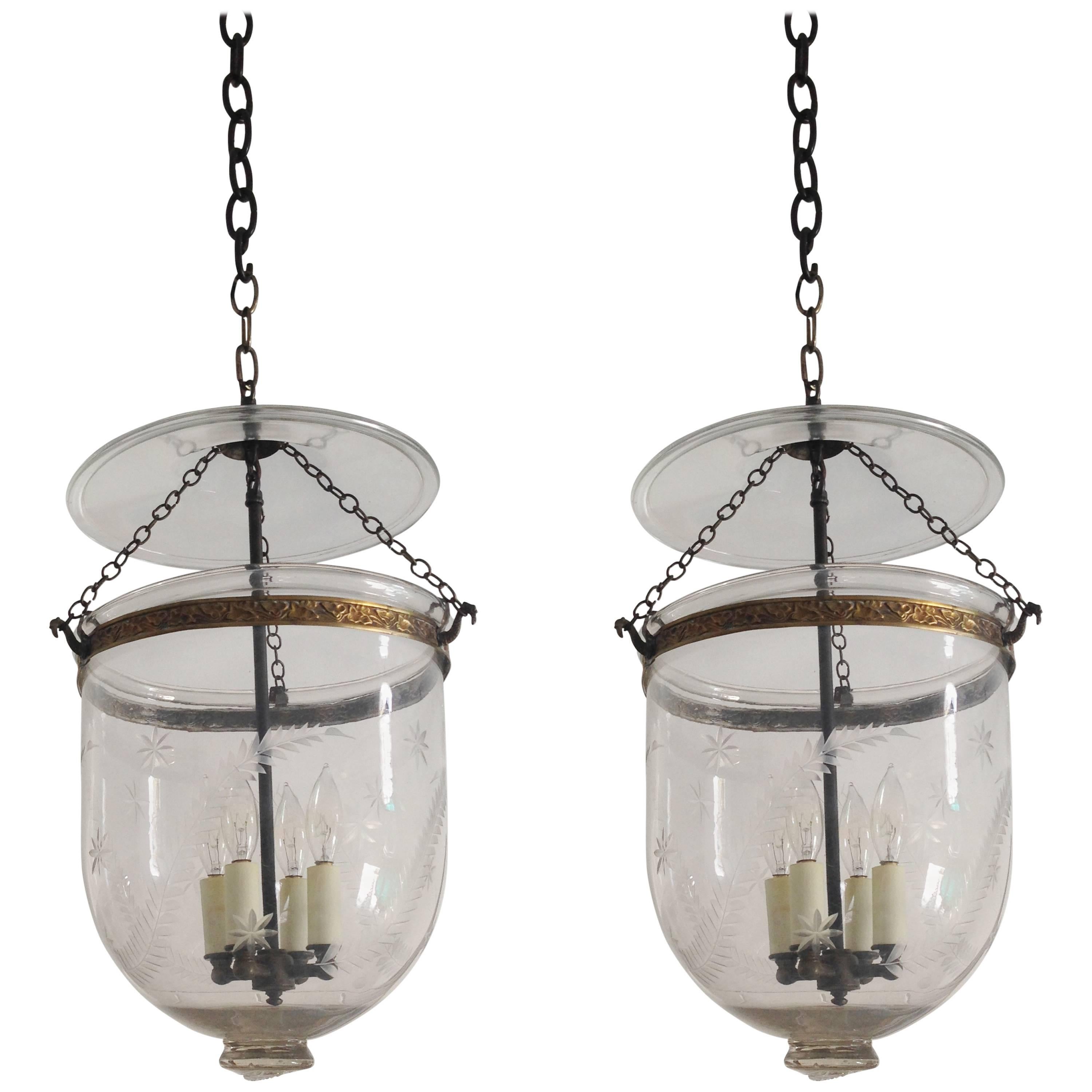 A pair of Austrian blown glass bell jar hall lanterns or hundis with etched fern and star design. Originally used with candles, each of these lanterns has been electrified with a four candle socket drop while maintaining the integrity of the