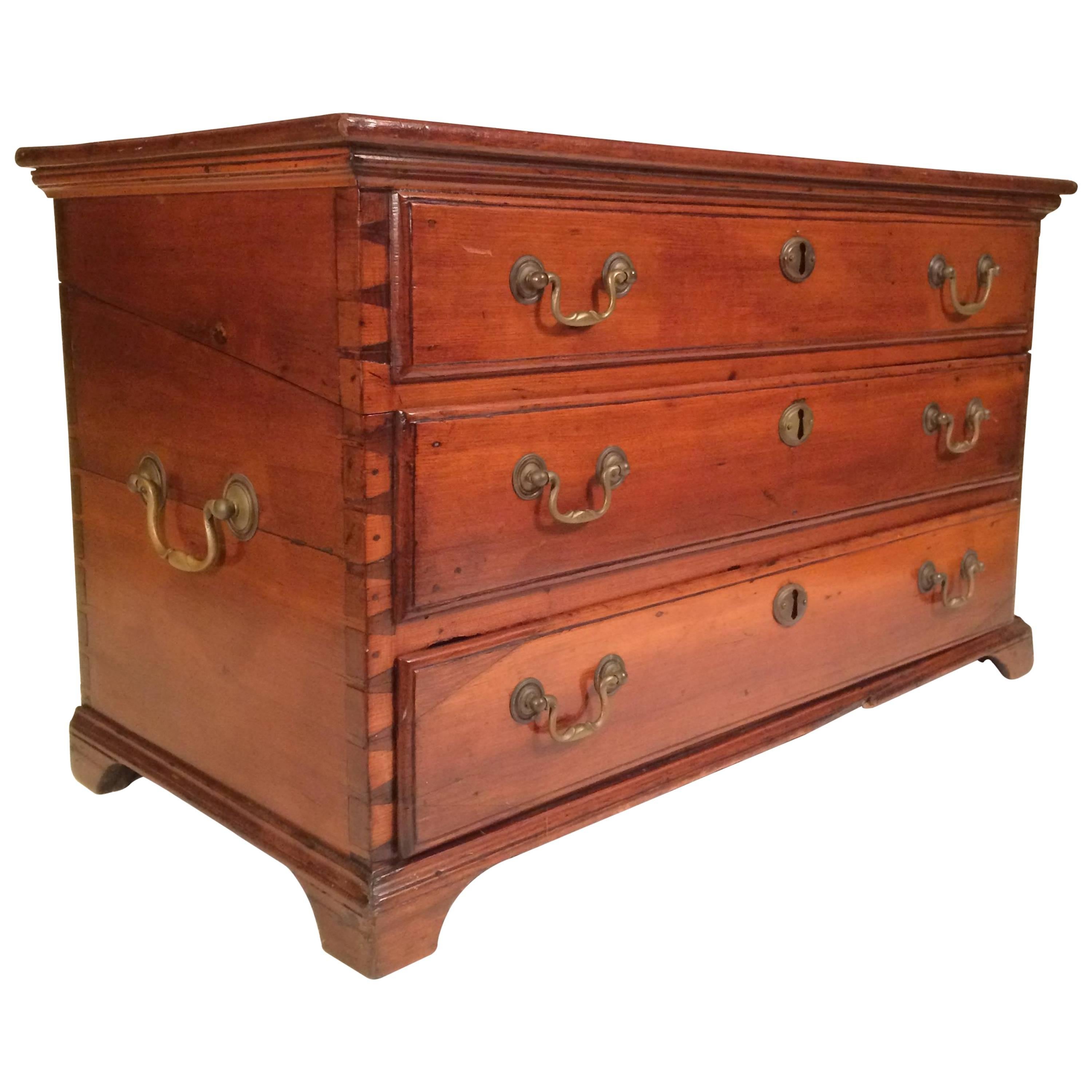 19th century English maritime carrying chest, possibly from a ship. Hinged lid with two false drawers above operational bottom drawer with compartments. Brass handles and escutcheon plates. A beautiful display piece, this case could also be utilized