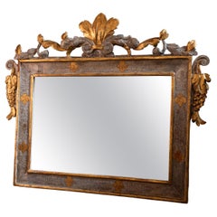 18th century baroque mirror in a gilded wooden frame decorated with flowers