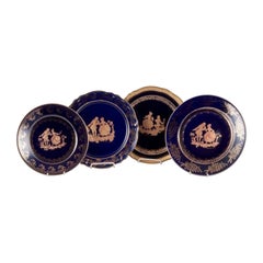 Limoges, France. Four plates in porcelain decorated with 22-karat gold leaf.