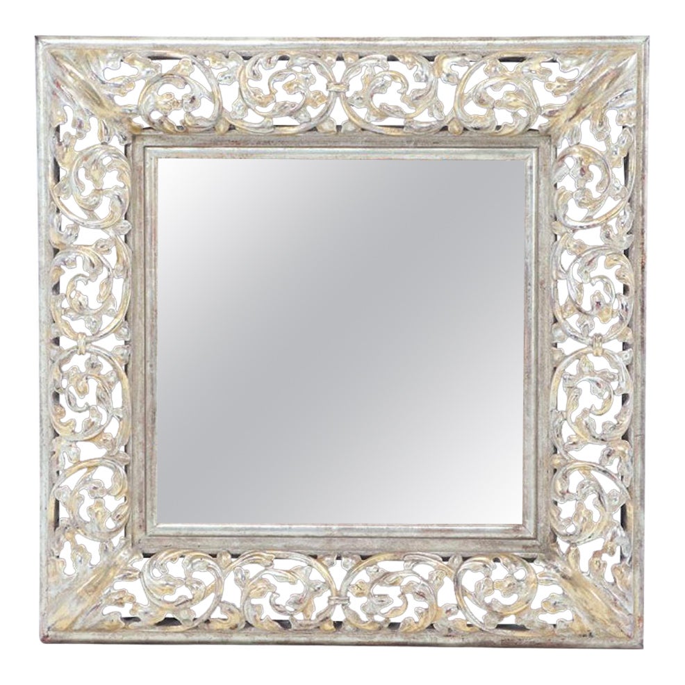 A silver gilt carved wood mirror.