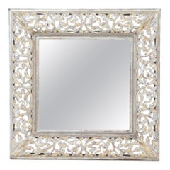 A silver gilt carved wood mirror.