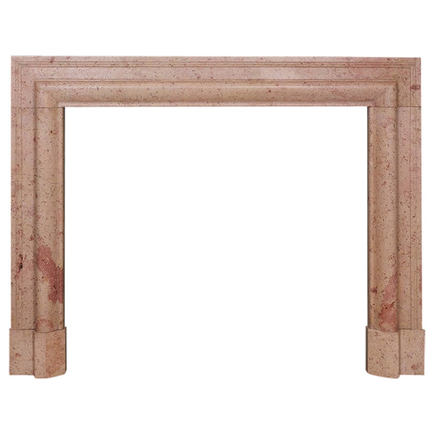 A Polished Bolection Chimneypiece in Red-Veined Limestone