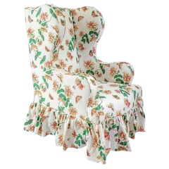 The Clementine Wing Chair, with Frilled Skirt upholstered in Honeysuckle